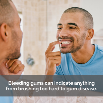 Man checking for bleeding gums in the mirror.