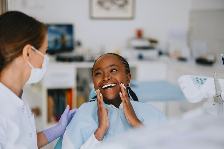 Happy female dental patient expresses joy after a successful checkup